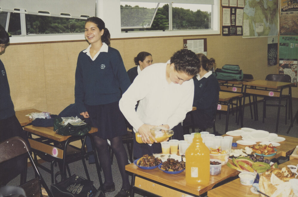 Students sharing food in classroom