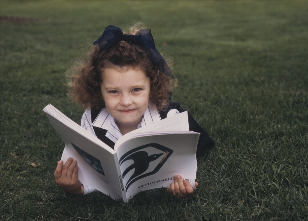 Student posing with Kristin Yearbook