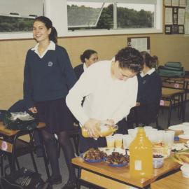Students sharing food in classroom
